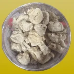 An overhead shot of authentic Bangladeshi Dailer Bori (sun-dried lentil dumplings) in a clear container.