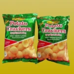 bombay-sweets-spicy-tomato-potato-crackers Two green packages of Bombay Sweets Spicy Tomato Potato Crackers, a crispy Bangladeshi snack.