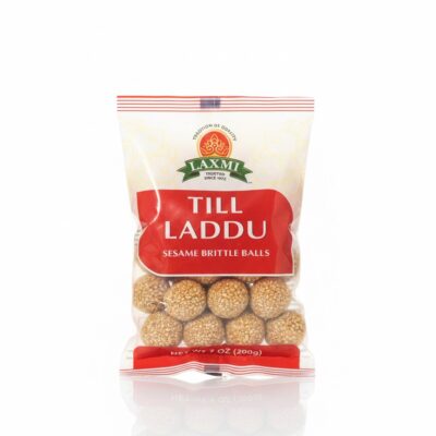 Front view of Laxmi brand Till Laddu (Sesame Brittle Balls) 7 oz bag showing golden sesame seed snacks.